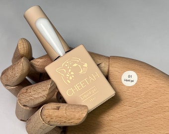 May include: A small bottle of clear liquid gel nail polish with a cheetah print design on the label. The label also says "CHEETAH Liquid gel 15ml" and "01 Liquid gel".