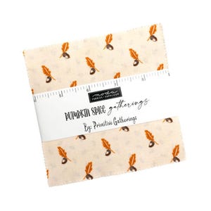 May include: A stack of fabric squares with a cream background and a repeating pattern of orange feathers and acorns. The fabric is wrapped with a white band that reads "Pumpkin Spice Gatherings By: Primitive Gatherings."