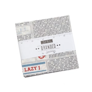 May include: A bundle of square fabric pieces with a newspaper-style print, labelled "Branded" by Sweetwater. The fabric features ranch names and a ruler graphic. The text "Lazy J" is printed in red.