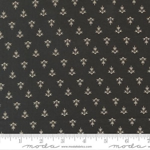 May include: Dark grey fabric featuring a repeating pattern of small, cream-coloured tree-like shapes. The fabric is measured with a ruler in inches, with the Moda Fabrics logo visible.