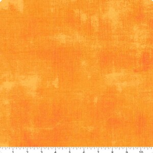 May include: Orange fabric with a textured, painterly effect. The fabric has a mottled appearance with variations in colour and tone, creating a visually interesting surface. The overall colour is a vibrant orange with lighter, yellowish highlights.