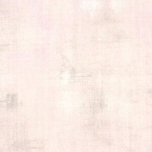 May include: A textured background in pale pink and off-white. The surface has a distressed appearance with subtle variations in tone and texture, creating a vintage or weathered aesthetic.