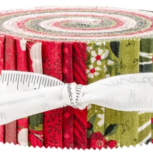 May include: A rolled bundle of fabric strips in red, green, and white. The fabric features floral and patterned designs. A white ribbon with measurements wraps around the bundle, securing the fabric. The fabric is likely for quilting or other crafts.
