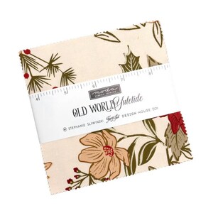May include: A bundle of square fabric pieces featuring a floral and botanical design in cream, brown, red, and green. The fabric is wrapped with a label that reads "OLD WORLD Yuletide" and "moda FABRIC SUPPLIES".