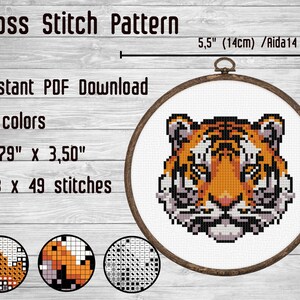 Könnte beinhalten: Kreuzstichmuster eines Tigergesichts in 7 Farben. Das Muster ist 9,6 cm x 8,9 cm groß und verwendet 53 x 49 Stiche. Das Muster ist für Aida 14er Stoff.