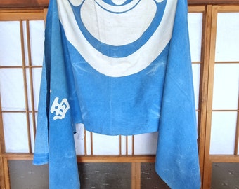 May include: A blue fabric banner with a white circle design and the word "魚" in white lettering. The banner is hanging from a wooden frame.