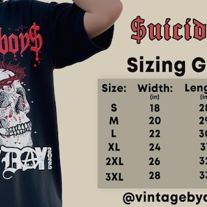 May include: Black t-shirt with a skull wearing a crown of thorns and the text "$uicideboy$ GREY DAY 2023". The shirt has a sizing chart with measurements in inches.