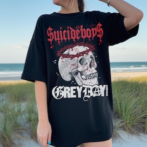 May include: Black t-shirt with a graphic print of a skull wearing a crown of thorns. The text "Suicideboys" and "Grey Day" are printed on the shirt.