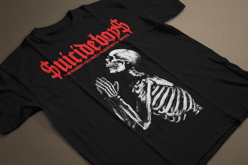 May include: Black t-shirt with a red graphic of a skeleton praying with the text "Suicideboys" and the phrase "The number you have dialed is not in service".