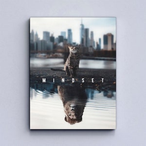 May include: A motivational poster featuring a cat sitting on a city street with a reflection of a lion in a puddle of water. The text "MINDSET" is printed below the cat.