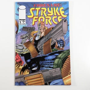 May include: Comic book cover featuring a group of characters in a futuristic setting. The cover is blue, yellow, and red with the title "Codename: Stryke Force" in large, bold letters. The characters are armed with guns and appear to be in a battle.