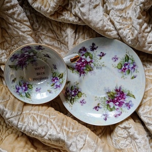 You&#39;ve been poisoned bye teacup saucer altered china gift custom purple pansy personalized poison cup message at bottom murderino