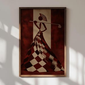 May include: Abstract art print featuring a figure in a checkered dress holding a golf club. The artwork is framed in a wooden frame and has a color palette of red, brown, and cream. The figure has a fan-shaped headpiece.