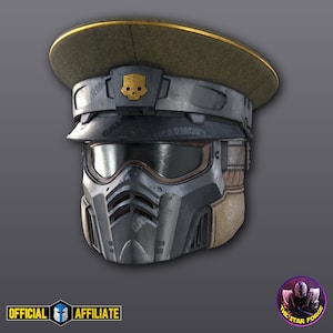 May include: A futuristic helmet with a military-style cap in olive green and a gold trim. The helmet is primarily gray with a visor and a skull emblem. The text "TICARMORY" is visible on the helmet.