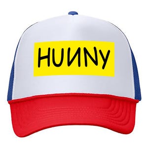 May include: A white, blue, and red trucker hat with a yellow patch that says "HUNNY" in black lettering.