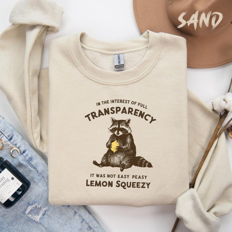 In The Interest Of Full Transparency It Was Not Easy Peasy Lemon Squeezy Sweatshirt, Funny Saying Sweatshirt, Cute Raccoon Sweatshirt