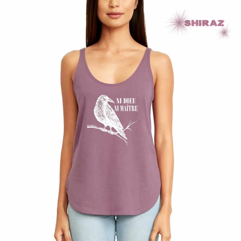 May include: A mauve tank top with a white graphic of a raven perched on a branch. The text "NI DIEU NI MAITRE" is printed below the raven.