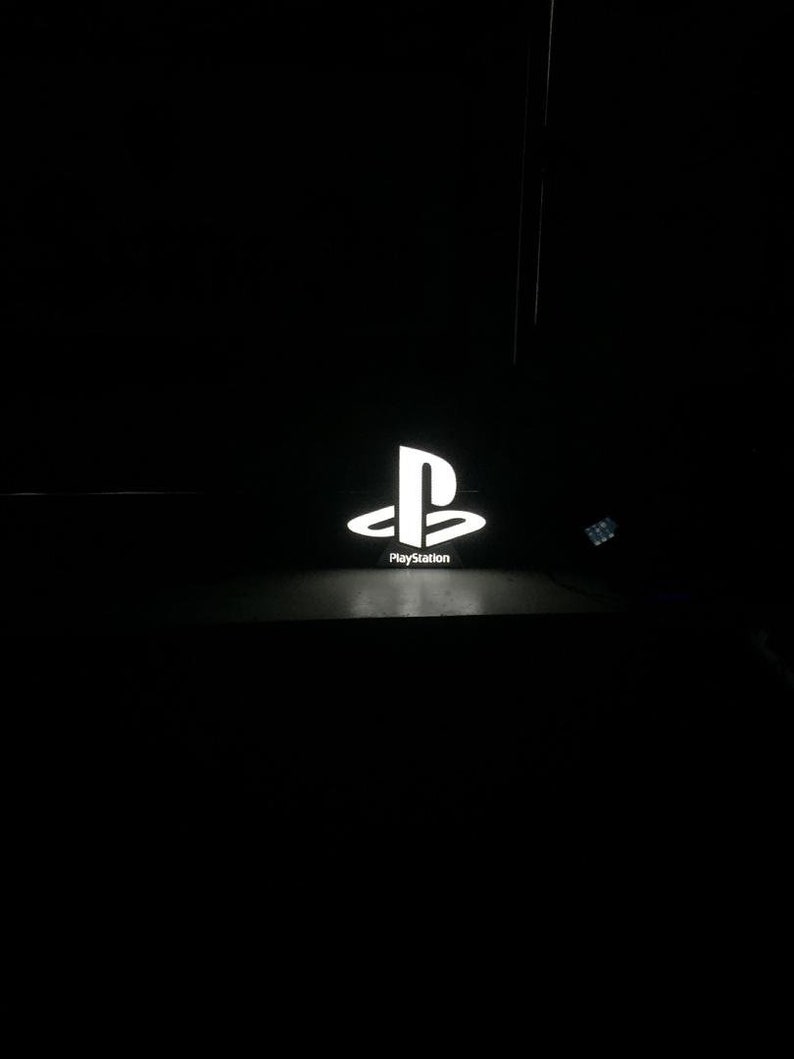 May include: A white PlayStation logo with the word "PlayStation" underneath it.
