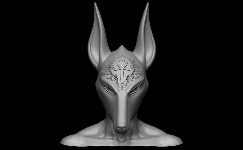 May include: A gray sculpture of a jackal-headed figure, possibly Anubis, with large ears and detailed facial features. An ankh symbol is etched on the forehead, with decorative swirls. The figure is set against a black background.