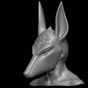 May include: A gray Anubis mask with tall ears and a long snout, set against a black background. The mask features detailed eye and brow shapes, with an ornate design on the forehead. The sculpture is a 3D render.