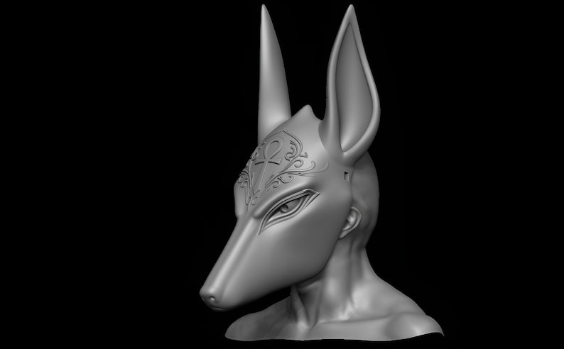 May include: A gray Anubis mask with tall ears and a long snout, set against a black background. The mask features detailed eye and brow shapes, with an ornate design on the forehead. The sculpture is a 3D render.