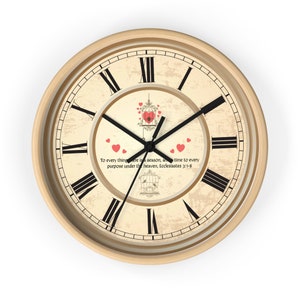 May include: A vintage-style wall clock with Roman numeral markings and a distressed beige background. The clock features a black metal frame and hands, and a quote from Ecclesiastes 3:1-8 about the season for everything. The clock has a decorative design with birds and hearts.