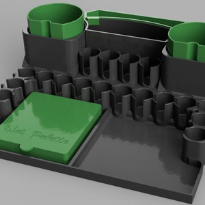 May include: A black and green plastic organizer with multiple compartments for paint brushes, a wet palette, and two paint pots.