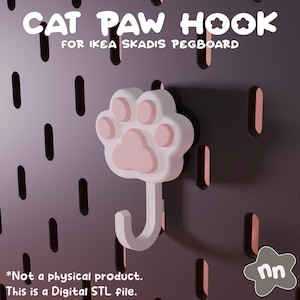 Könnte beinhalten: Ein weißer und rosa Katzenpfoten-Haken für eine IKEA SKADIS Lochwand. Der Haken hat die Form einer Katzenpfote mit einem gebogenen Haken. Der Text "CAT PAW HOOK" und "FOR IKEA SKADIS PEGBOARD" ist sichtbar. Der Text "*Not a physical product. This is a Digital STL file." ist ebenfalls sichtbar.