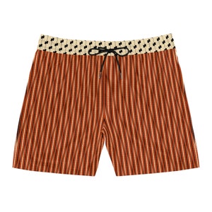 May include: Orange and black striped swim trunks with a white and black patterned waistband.
