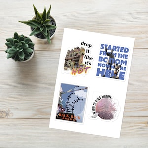 May include: Four colorful stickers featuring Disney World attractions. The first sticker shows the Hollywood Tower Hotel with the text "drop it like it's hot". The second sticker shows a blue background with the text "Started from the bottom now we're here". The third sticker shows a blue and white illustration of a roller coaster with the text "Back, Back, Back it up". The fourth sticker shows a purple and white illustration of the Spaceship Earth with the text "Word to your mother".