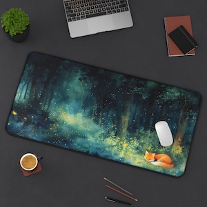 May include: A green and blue forest scene with a sleeping fox and a computer mouse. The scene is printed on a black mouse pad.