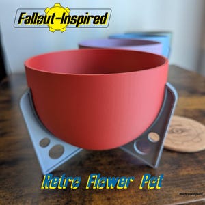 May include: A red flower pot with a rounded bowl shape, supported by a gray, angular stand. The pot has the text "Retro Flower Pot" and "Fallout-Inspired" in yellow and blue. Other colored pots are visible in the background.