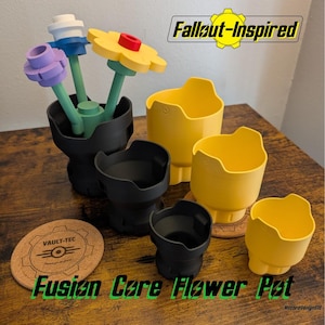 May include: A collection of 3D-printed flower pots and decorative flowers. The set includes black and yellow pots, and colorful flowers with green stems. The image also features a cork coaster with a logo and the text "Fusion Core Flower Pot" and "Fallout-Inspired".