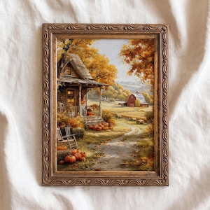 May include: A framed wall art print depicting a rustic cabin scene during autumn. The image features a wooden porch with orange pumpkins, a rocking chair, golden trees, and a red barn in the distance. The frame is ornate, metallic bronze with a wavy pattern.