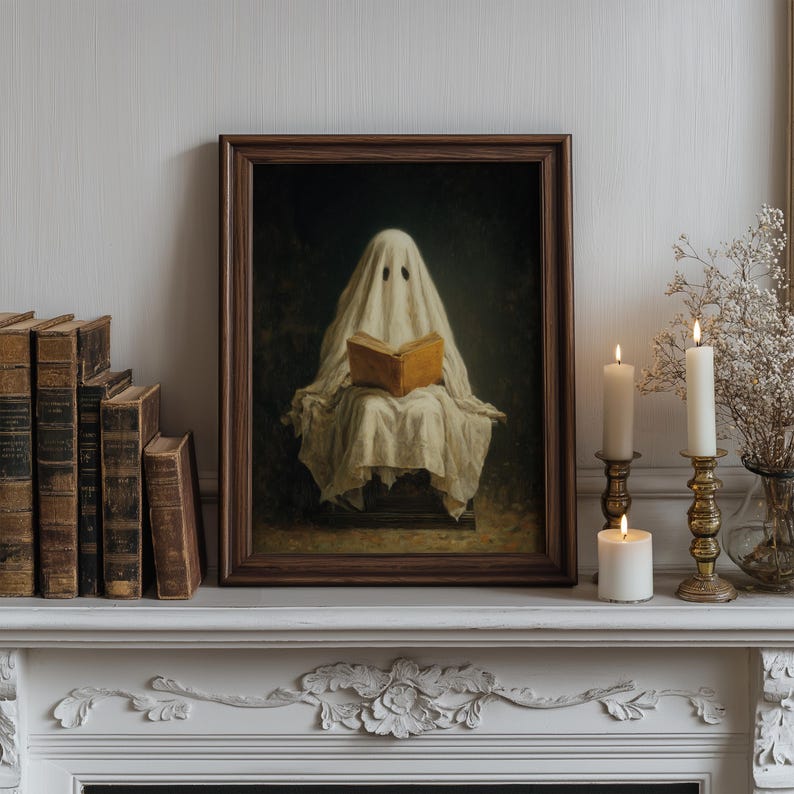 May include: A framed wall art print featuring a figure draped in a white sheet with two dark eye holes, sitting and holding an open tan book. The artwork is set against a dark background and enclosed in a dark brown wooden frame.