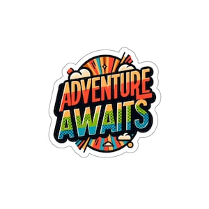 May include: A colorful sticker with a retro comic book style design. The sticker says "Adventure Awaits" in bold, black letters with a rainbow-colored background.