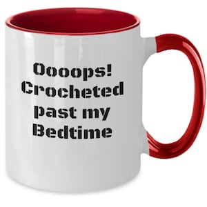 May include: White ceramic coffee mug with a red rim and handle. The mug has black text that reads "Oooops! Crocheted past my Bedtime".