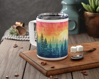 May include: A white ceramic mug with a rainbow sunset and silhouette of trees design. The mug has a white handle and a stainless steel lid.