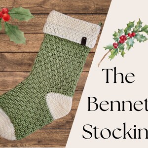 May include: A green and cream-coloured crocheted Christmas stocking with the text "The Bennet Stocking". The stocking features a textured weave pattern and a cream-coloured cuff and toe. A small leather tag is attached to the cuff.