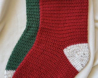 May include: A red, green, and white crocheted Christmas stocking with a brown leather tag that says "Good Luck" hanging from the top.