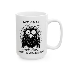 May include: White ceramic mug featuring a cartoon bird with large eyes and a bewildered expression. The bird is black with white accents. The mug has the text "BAFFLED BY GENETIC GENEALOGY" in black.