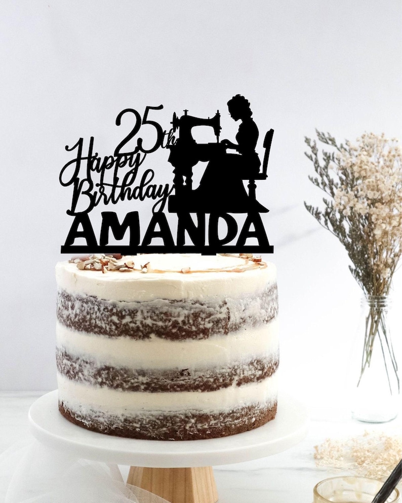 a birthday cake with a silhouette of a woman and a sewing machine