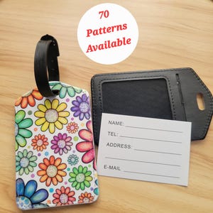 May include: A colorful luggage tag with a floral pattern and a black leather strap. The tag has a white background with colorful flowers and polka dots. The tag also has a black leather card holder with a clear window for a photo ID. The card holder has spaces for name, phone number, address, and email. The text "70 Patterns Available" is written on a white circle with a red border.