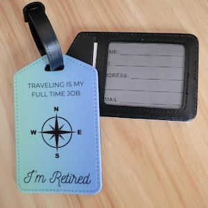 May include: Blue luggage tag with a compass and the text "Traveling is my full time job I'm Retired". The tag has a black strap and a black and white address card.