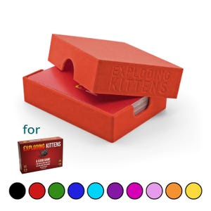 May include: A red card game storage box with the text EXPLODING KITTENS embossed on the lid. The box contains a deck of cards. Below is a small image of the Exploding Kittens game box and a row of ten coloured circles in black, red, green, blue, cyan, purple, magenta, pink, orange, and yellow.