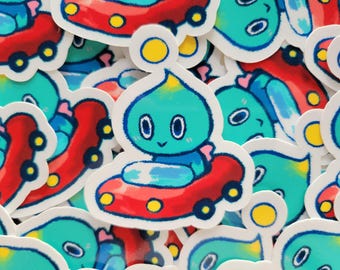 May include: A collection of colorful stickers featuring a blue character with a yellow halo driving a red car. The stickers are perfect for adding a touch of whimsy to laptops, water bottles, or journals.