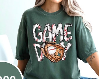 May include: A green t-shirt with the text "GAME DAY" in white with a baseball and glove graphic.