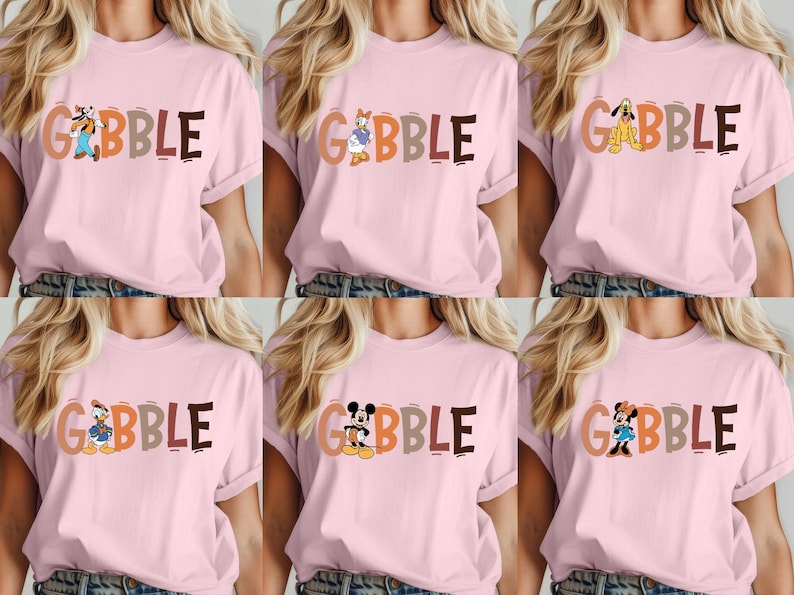May include: Pink t-shirts with the word "GOBBLE" in colorful letters and various cartoon characters. The characters include Goofy, Daisy Duck, Pluto, Donald Duck, Mickey Mouse, and Minnie Mouse. The shirts are casual wear.