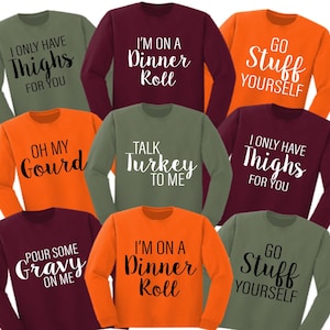 May include: Nine long-sleeved shirts with various Thanksgiving-themed sayings. The shirts are in orange, green and maroon.