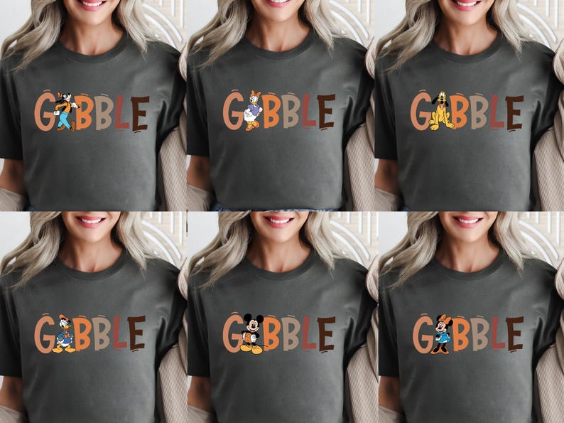 May include: A dark gray t-shirt with the word "GOBBLE" in orange and brown letters. Each shirt features a different cartoon character, including Goofy, Donald Duck, Pluto, Daisy Duck, Mickey Mouse, and Minnie Mouse.